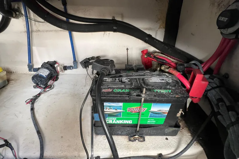 Slide: The Image of Battery compartment of a 2004 Sea Ray 240 Sundeck with marine cranking battery. - 17