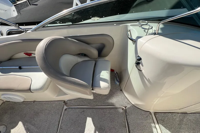 Slide: The Image of 2004 Sea Ray 240 Sundeck interior with seating and cup holders. - 7