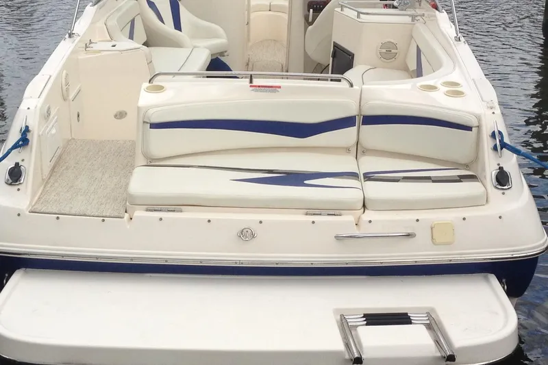 Slide: The Image of 2004 Rinker 282 Captiva Bowrider with spacious seating and swim platform on water. - 10