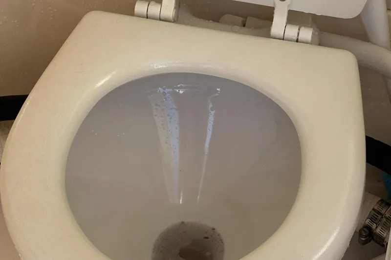 Slide: The Image of 2004 Rinker 282 Captiva Bowrider marine toilet interior view. - 12