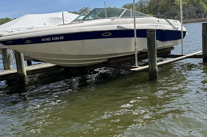 Slide: The Image of 2004 Rinker 282 Captiva Bowrider on boat lift at dockside. - 3