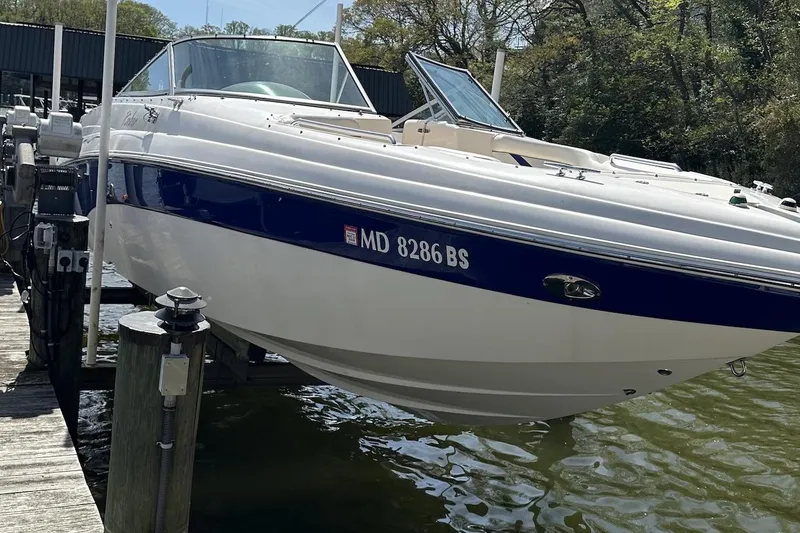 Slide: The Image of 2004 Rinker 282 Captiva Bowrider boat docked on a sunny day. - 5