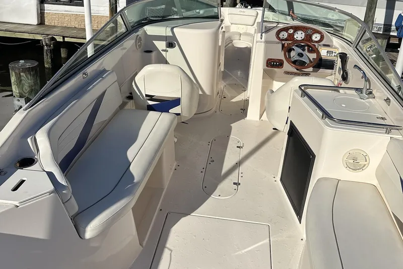 Slide: The Image of 2004 Rinker 282 Captiva Bowrider interior with seating, steering wheel, and dashboard. - 6