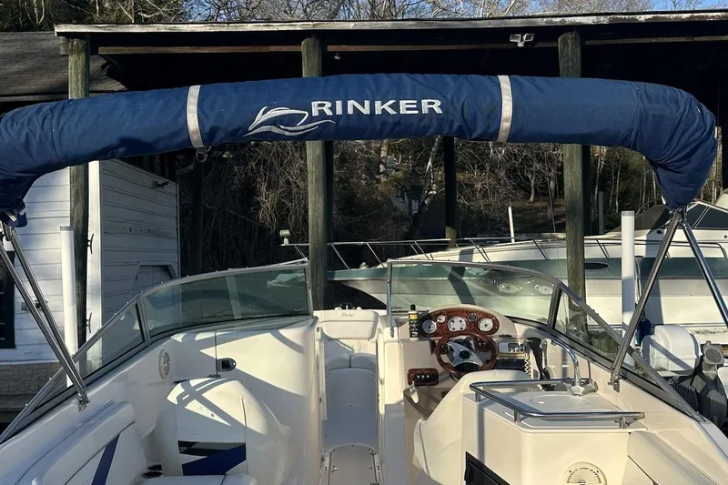 Slide: The Image of 2004 Rinker 282 Captiva Bowrider with blue canopy, docked at marina. - 8