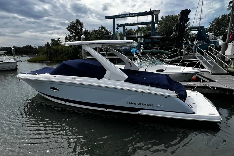 The Image of 2020 Chaparral 297 SSX boat docked at marina under cloudy sky. - 0