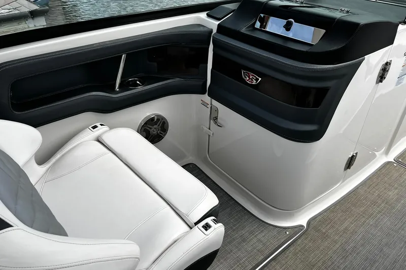 Slide: The Image of 2020 Chaparral 297 SSX boat interior with white seating and sleek dashboard design. - 13