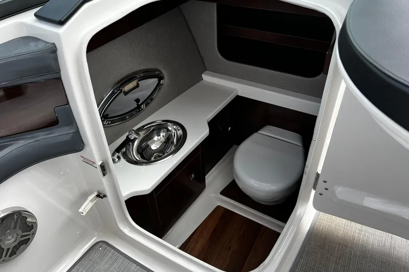 Slide: The Image of 2020 Chaparral 297 SSX boat interior with compact bathroom and sink. - 14