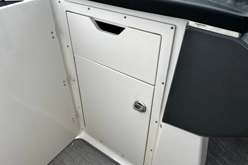 Slide: The Image of 2020 Chaparral 297 SSX boat interior storage compartment with sleek design. - 15
