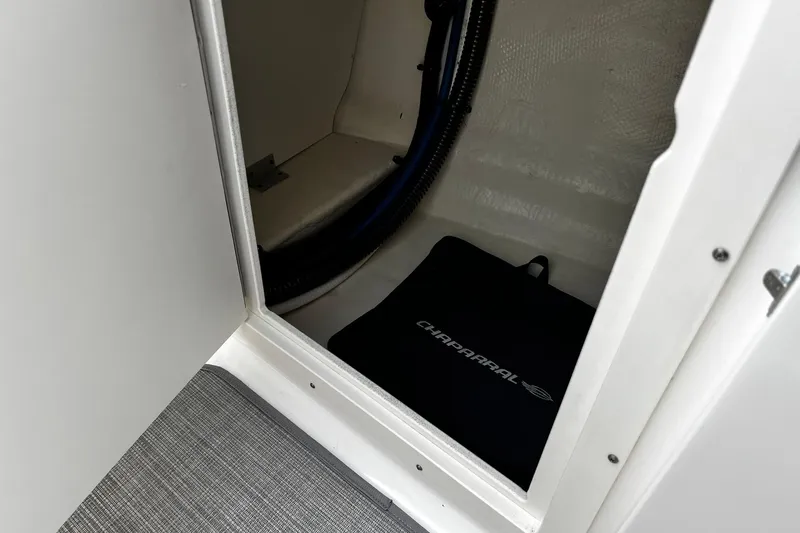Slide: The Image of 2020 Chaparral 297 SSX storage compartment with branded mat inside. - 16