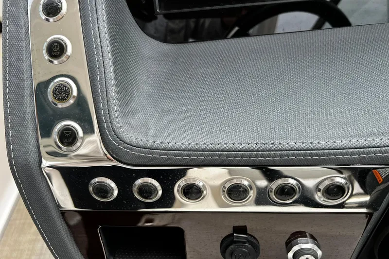 Slide: The Image of Control panel of 2020 Chaparral 297 SSX boat with various buttons and switches. - 24