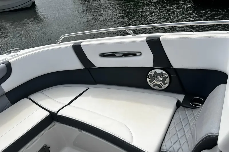 Slide: The Image of 2020 Chaparral 297 SSX boat interior with white and black seating, speaker, and cup holder. - 32