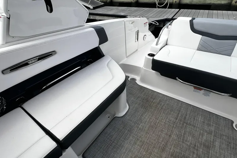 Slide: The Image of 2020 Chaparral 297 SSX boat interior with sleek white and black seating. - 6