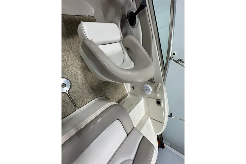 Slide: The Image of Interior of 2004 Sea Ray 200 Sundeck boat with beige seating and carpet. - 12