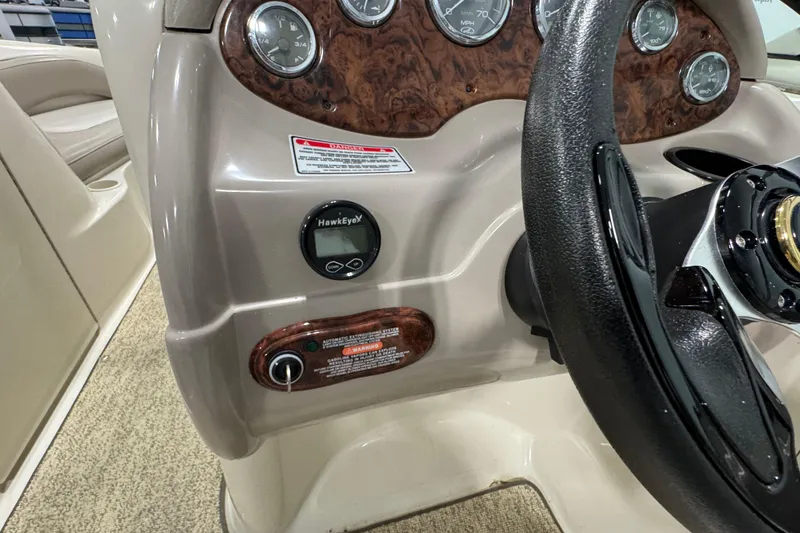 Slide: The Image of Dashboard of a 2004 Sea Ray 200 Sundeck boat with gauges and steering wheel. - 15