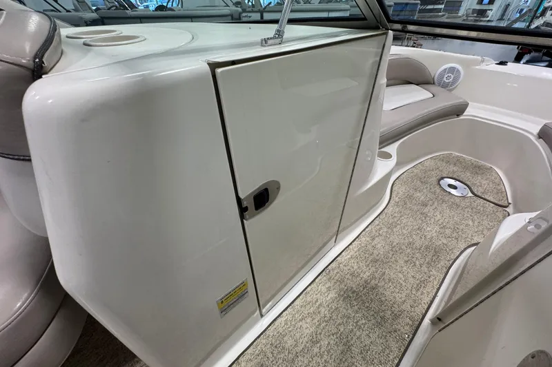 Slide: The Image of 2004 Sea Ray 200 Sundeck interior with seating and storage compartment. - 21