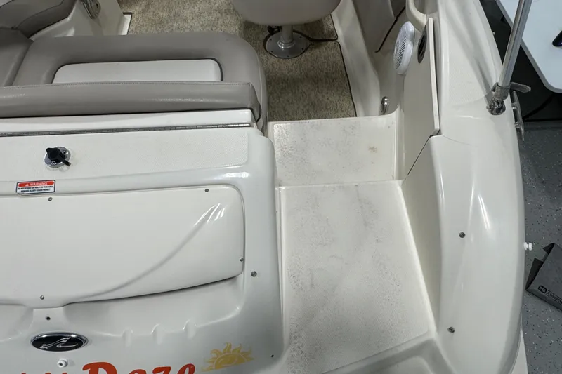 Slide: The Image of 2004 Sea Ray 200 Sundeck interior with seating and step detail. - 7