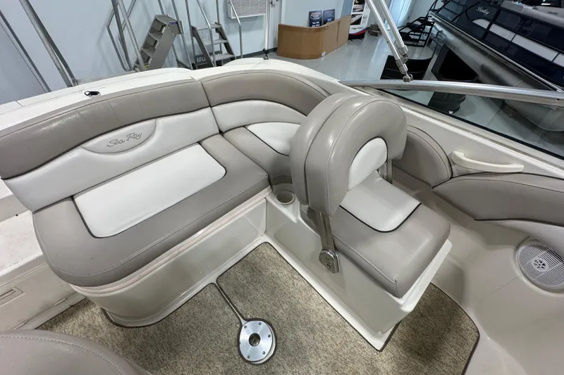 Slide: The Image of 2004 Sea Ray 200 Sundeck interior with beige and white seating. - 9