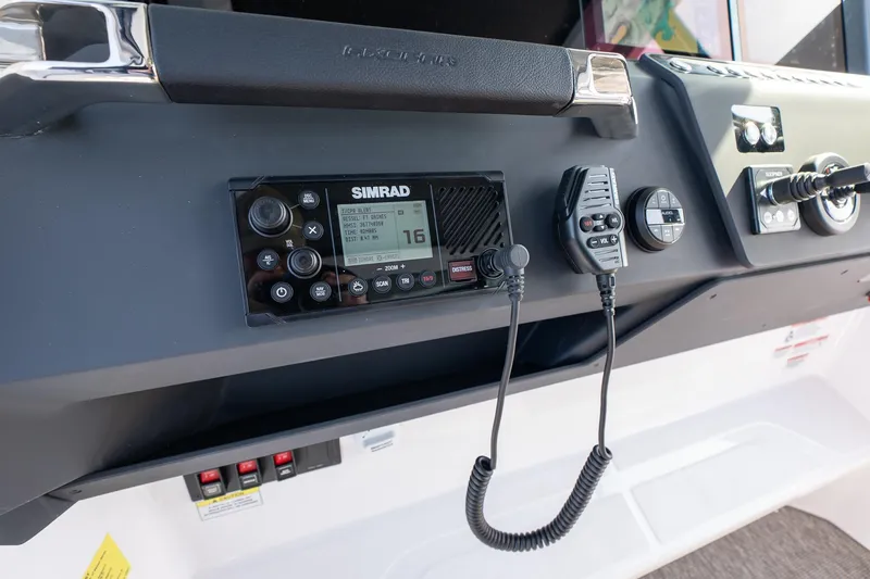 Slide: The Image of Control panel of 2026 Axopar 29 Cross Cabin with Simrad marine radio. - 32