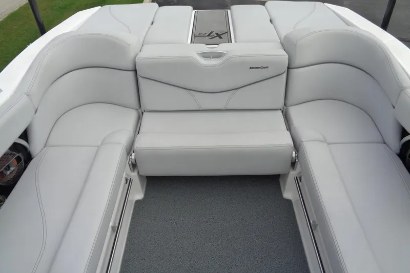 Slide: The Image of 2020 MasterCraft XT23 boat interior with luxurious white seating and modern design. - 12