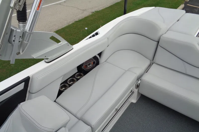 Slide: The Image of 2020 MasterCraft XT23 boat interior with sleek gray seating and cup holders. - 13