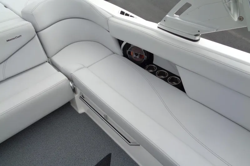 Slide: The Image of 2020 MasterCraft XT23 boat interior with white seating and cup holders. - 14