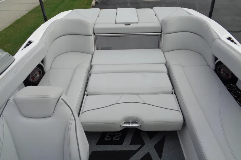 Slide: The Image of 2020 MasterCraft XT23 boat interior with luxurious white seating and modern design. - 16