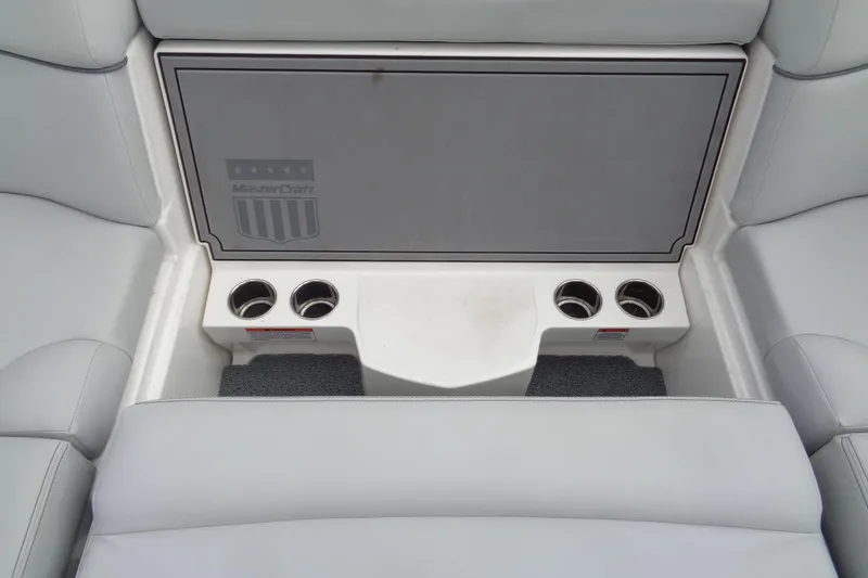 Slide: The Image of 2020 MasterCraft XT23 boat interior with cup holders and seating area. - 17