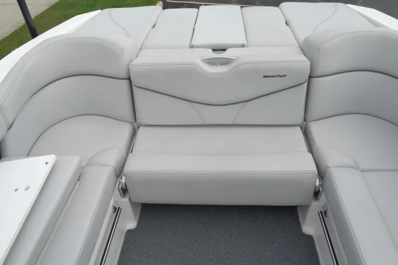 Slide: The Image of 2020 MasterCraft XT23 boat interior with sleek gray seating and modern design. - 18