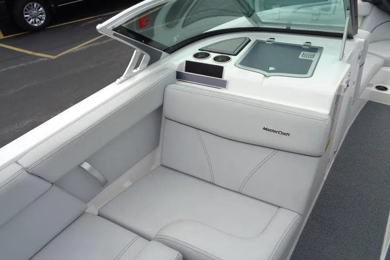 Slide: The Image of 2020 MasterCraft XT23 boat interior with sleek white seating and modern dashboard design. - 20