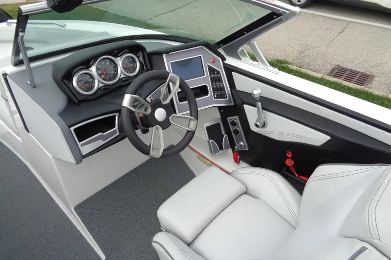 Slide: The Image of 2020 MasterCraft XT23 boat interior with modern dashboard and steering wheel. - 21