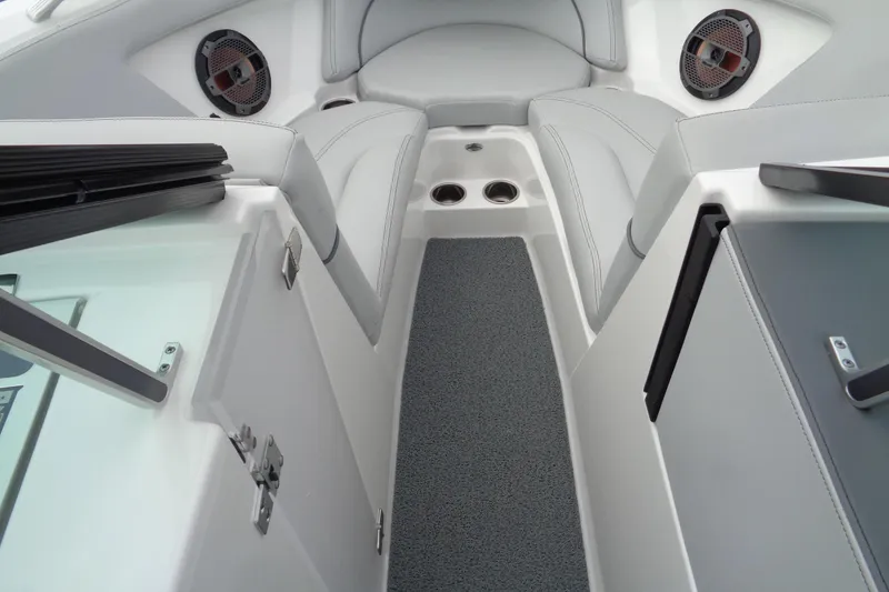 Slide: The Image of 2020 MasterCraft XT23 boat interior with gray seating and cup holders. - 23