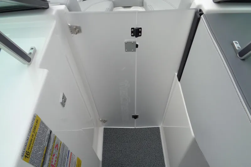 Slide: The Image of 2020 MasterCraft XT23 boat interior with safety capacity label and door. - 24