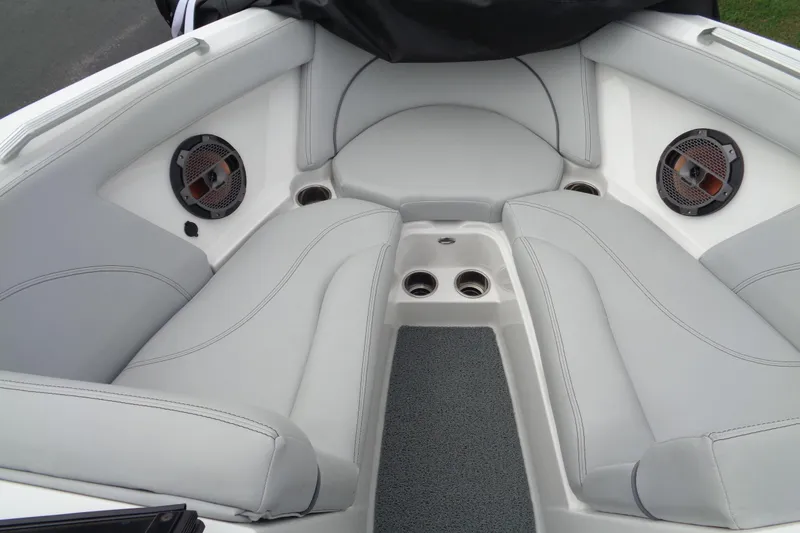 Slide: The Image of 2020 MasterCraft XT23 boat interior with gray seating and built-in speakers. - 25