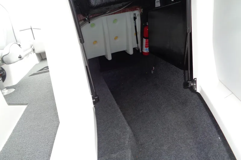 Slide: The Image of Interior view of 2020 MasterCraft XT23 boat storage area with fire extinguisher. - 28