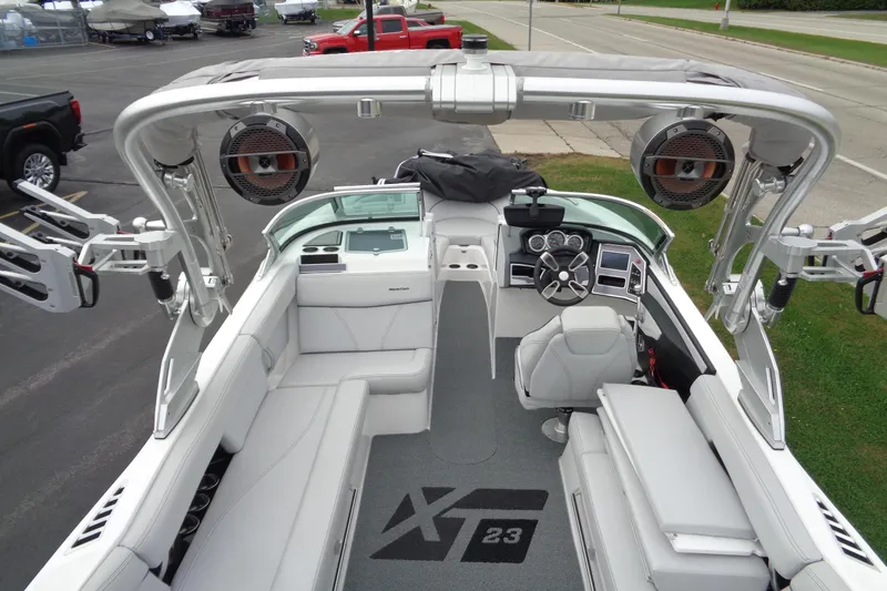 Slide: The Image of 2020 MasterCraft XT23 boat interior with sleek seating and advanced dashboard controls. - 39