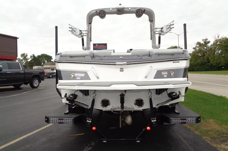Slide: The Image of 2020 MasterCraft XT23 boat rear view with wakeboard tower and dual exhaust. - 53