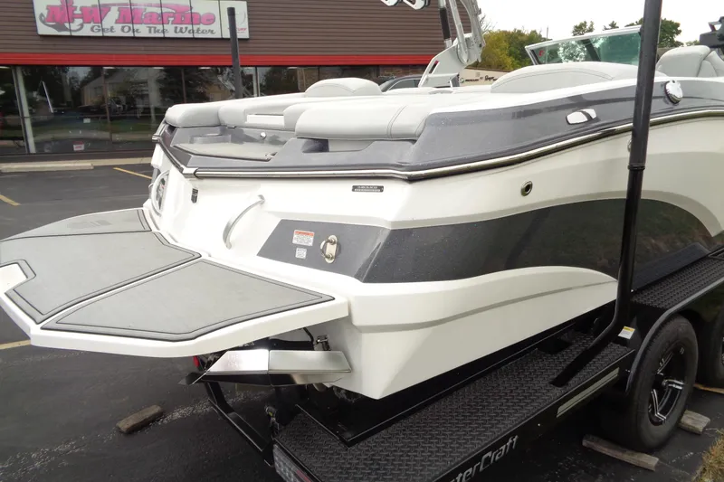 Slide: The Image of 2020 MasterCraft XT23 boat on trailer outside dealership. - 54