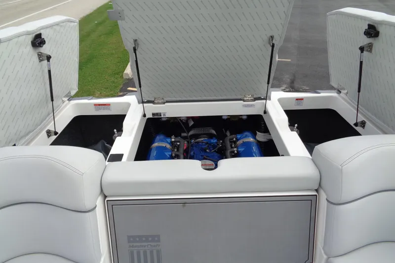 Slide: The Image of 2020 MasterCraft XT23 boat engine compartment with open hatches, showcasing interior details. - 6