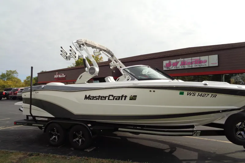 Slide: The Image of 2020 MasterCraft XT23 boat on trailer outside dealership. - 70