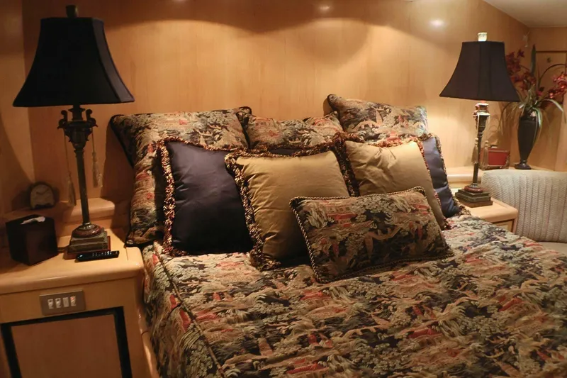 Slide: The Image of Luxurious bedroom interior on a 2001 Donzi 73 Sport Yacht with elegant bedding and lamps. - 25