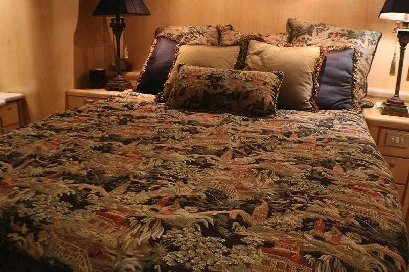 Slide: The Image of Luxurious bedroom interior on 2001 Donzi 73 Sport Yacht with ornate bedding and elegant lamps. - 26