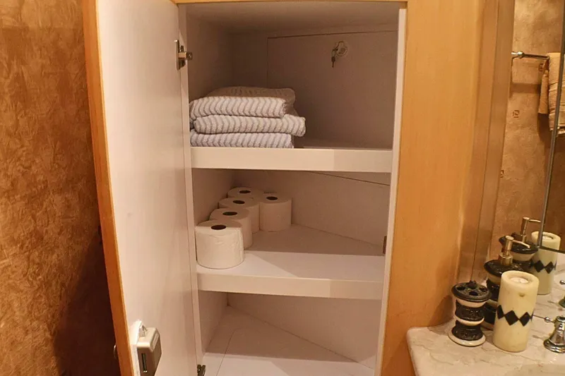 Slide: The Image of Cabinet with towels and toilet paper in 2001 Donzi 73 Sport Yacht bathroom. - 39