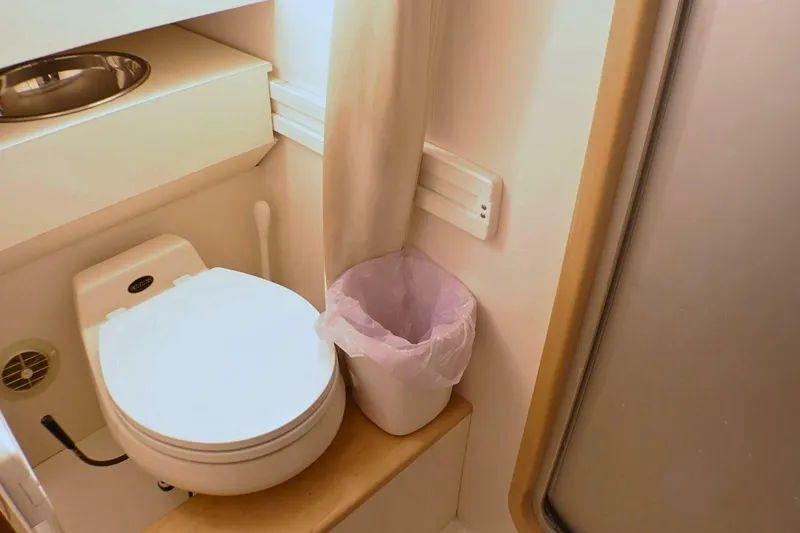 Slide: The Image of Bathroom interior of 2001 Donzi 73 Sport Yacht with toilet and trash bin. - 45