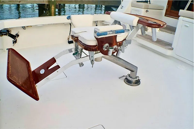 Slide: The Image of Fishing chair on 2001 Donzi 73 Sport Yacht deck, featuring sturdy design and white upholstery. - 67