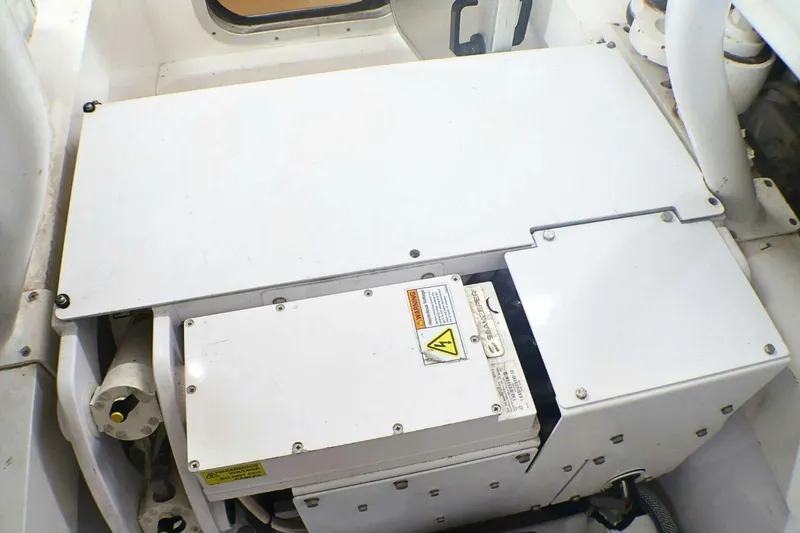 Slide: The Image of Engine compartment of a 2001 Donzi 73 Sport Yacht, featuring electrical components and warning labels. - 70