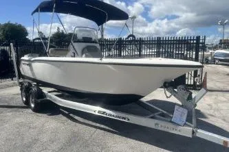 Slide: The Image of 2022 Key West 203 DFS boat on trailer with canopy, parked outdoors. - 2