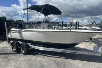 Slide: The Image of 2022 Key West 203 DFS boat on trailer, parked outdoors under cloudy sky. - 3
