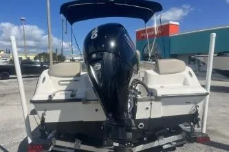 Slide: The Image of 2022 Key West 203 DFS boat with outboard motor, parked on a trailer. - 6