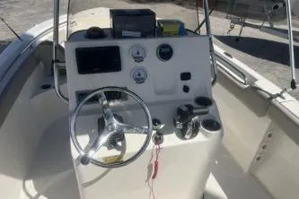 Slide: The Image of 2022 Key West 203 DFS boat dashboard with steering wheel and controls. - 8