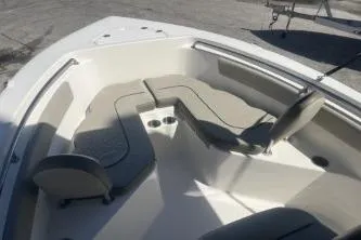 Slide: The Image of 2022 Key West 203 DFS boat interior with cushioned seating and cup holders. - 9